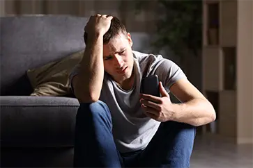 Man stressed looking at phone